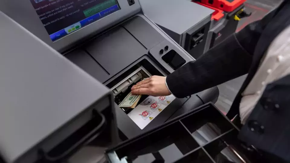 Person depositing cash in Loomis smart safe