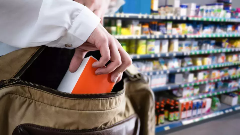 Man shoplifting a container