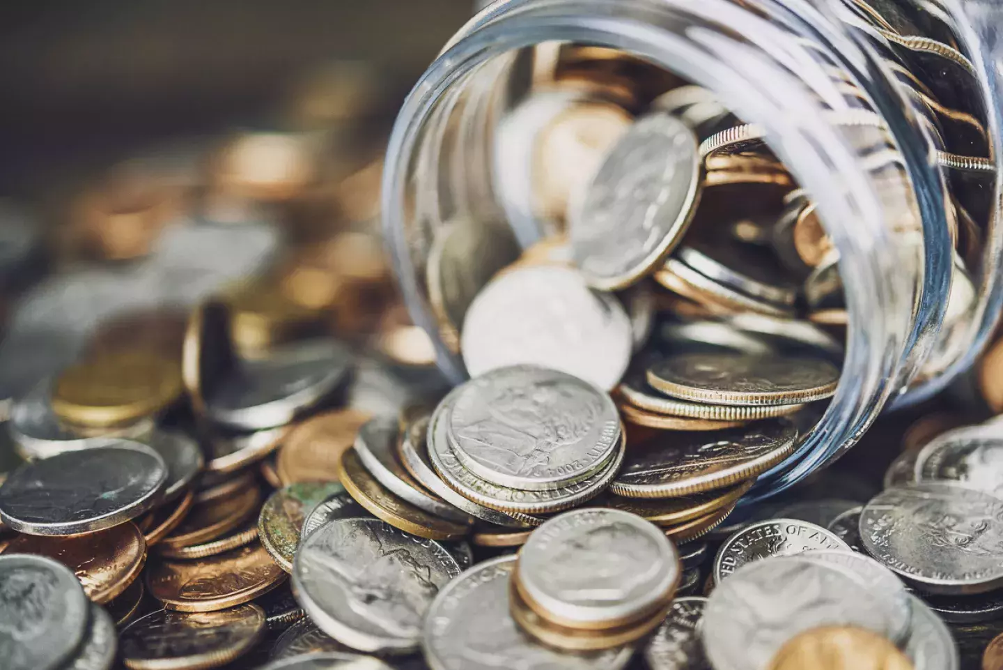 Coin spilling out from jar